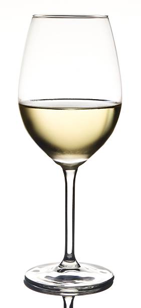 Half full white wine in glass with condensation stock photo