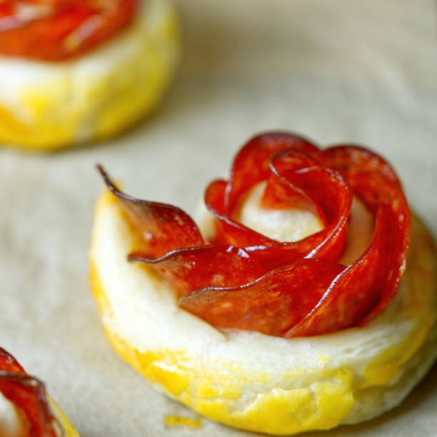 fresh homemade pastries. puff pastry appetizers mix. rose-shaped pepperoni cake. pastry with salami