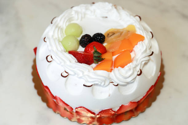 istock Fruit topping birthday cake on white background 1381698261