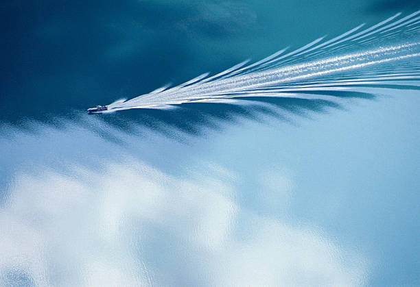 Wake of a motorboat on blue water