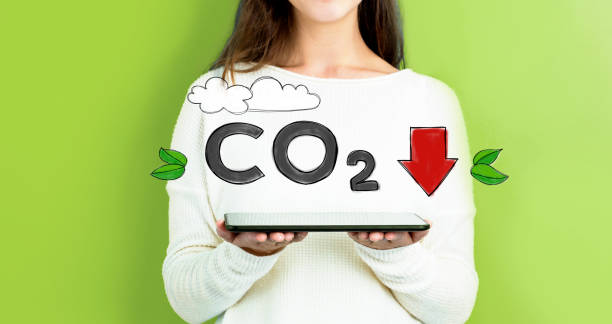 Reduce CO2 with woman holding a tablet stock photo
