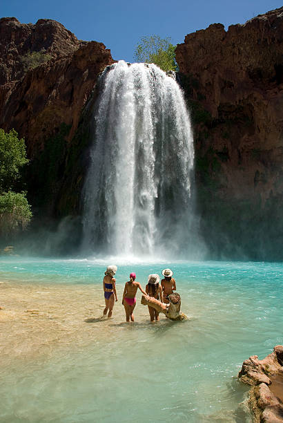 Beautiful Young Swimsuit Models in front of Havasu Falls Beautiful group of women standing in front of the world famous Havasu Falls in Arizona havasu falls stock pictures, royalty-free photos & images