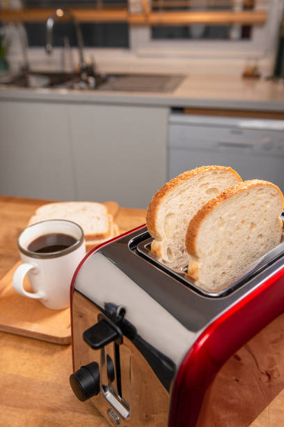istock On the kitchen table is a red toaster and a cup of coffee. 1381736999