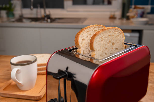 istock On the kitchen table is a red toaster and a cup of coffee. 1381737535