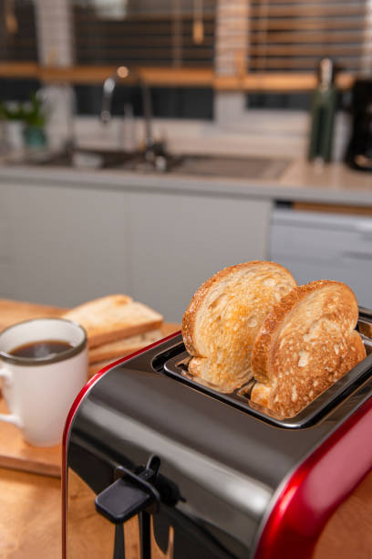 istock On the kitchen table is a red toaster and a cup of coffee. 1381738042