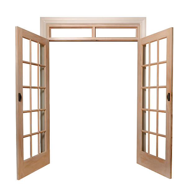 Light brown French doors opening up to a white background stock photo