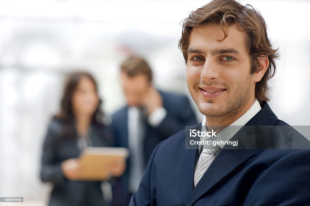 Business team Confident businessman with colleagues in the background 20-24 Years Stock Photo