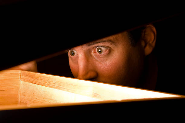 Surprised at a discovery A man is surprised by what he finds in a box. See also:  peeking photos stock pictures, royalty-free photos & images