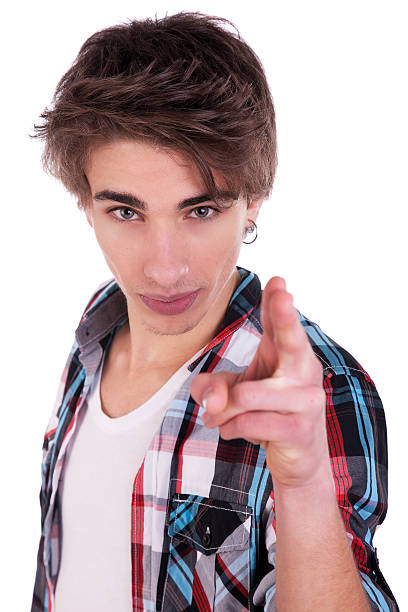 Happy young man pointing stock photo