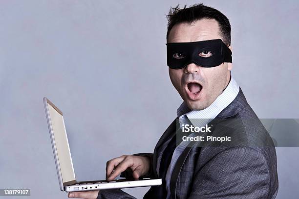 Businessman With Mask And Laptop Stock Photo - Download Image Now - Computer Hacker, Computer Crime, Mask - Disguise