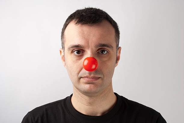 istock Serious man wearing a clown nose 138179473