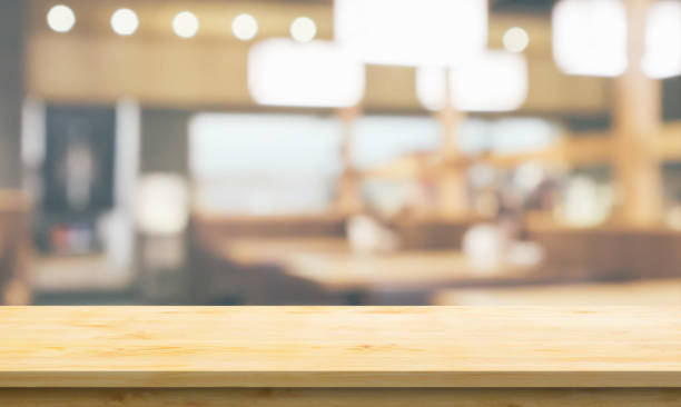 istock Empty wood table top with cafe restaurant interior blurred background 1381794766