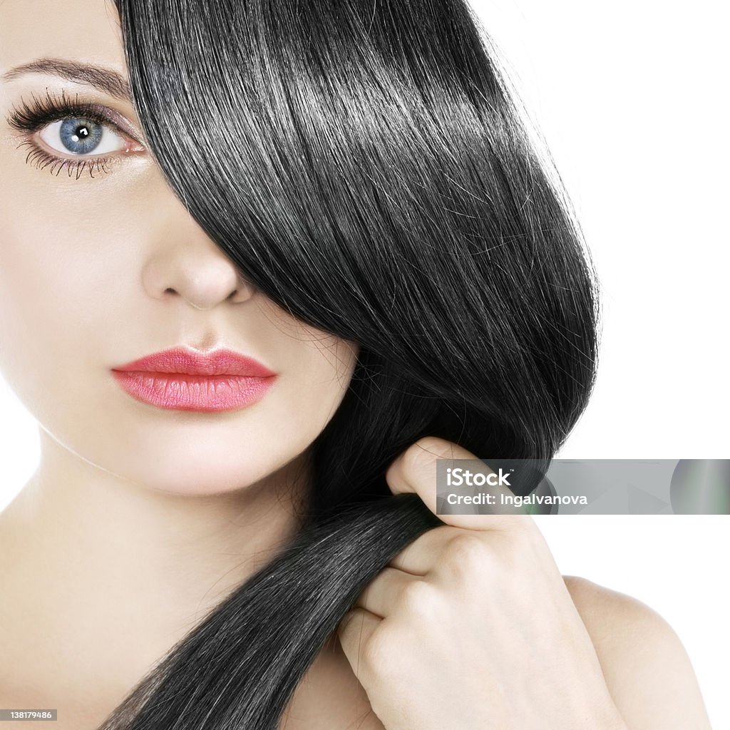 Women gently pulling her straight black hair over one eye Woman with black hair Close-up Stock Photo
