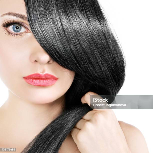 Women Gently Pulling Her Straight Black Hair Over One Eye Stock Photo - Download Image Now