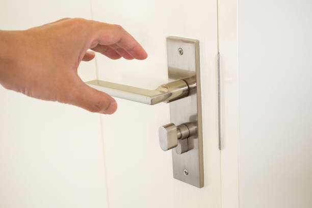istock Man hand holding door handle close up 1381795965