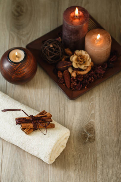 High angle view of a small arrangement of candles, incense and towels at the spa for a better experience.