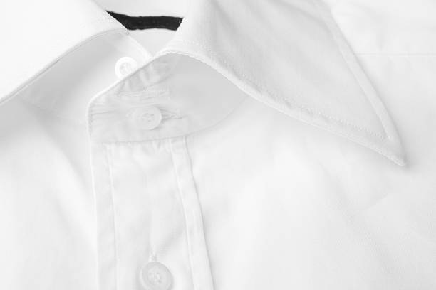 macro closeup of mens long sleeve dress shirts collars work lined up in a row closet backdrop. elegant professional lifestyles backdrop of home or retail environment design element