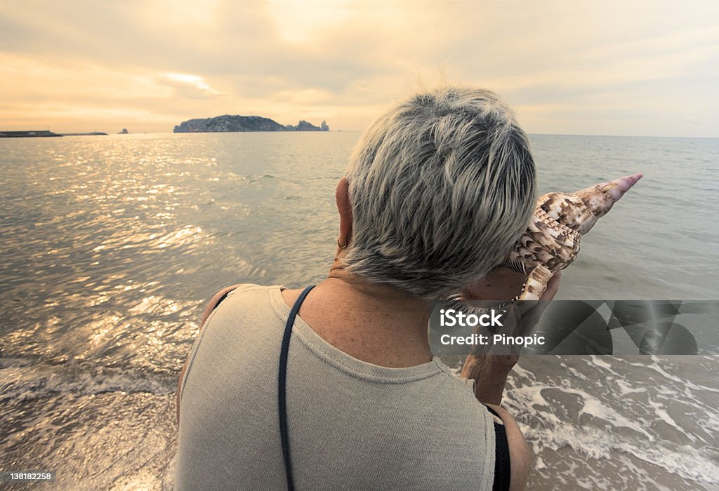 World hablar, i'm escucha mujer con conch junto al mar - Foto de stock de Escuchar libre de derechos