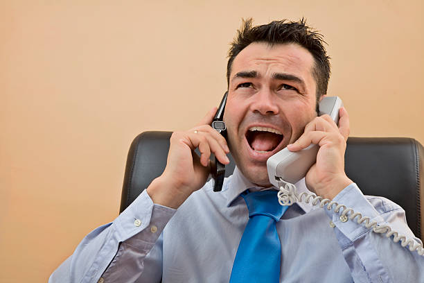 Businessman  yelling on the phones.