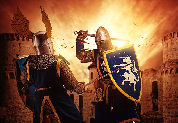 Two knights fighting against medieval castle. stock photo