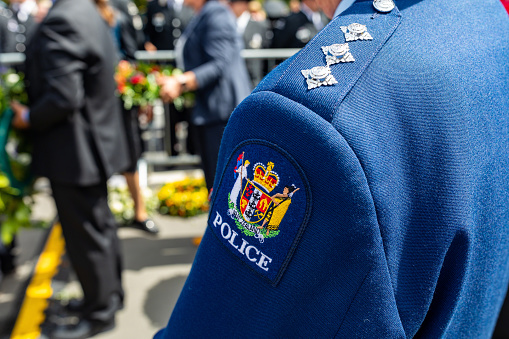 FILE - 22 February 2021, Christchurch, New Zealand. A member of the New Zealand Police stands at the national memorial service marking the 10th anniversary of the Canterbury earthquakes.