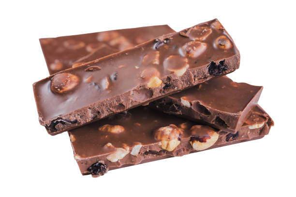 istock Chunks of chocolate with hazelnuts and raisins isolated on white background 1381870671
