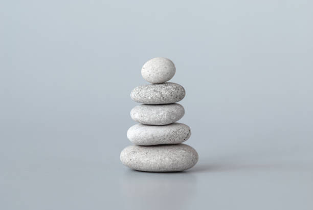 istock Pebbles stack on grey background, zen balance meditation minimal concept 1381874137