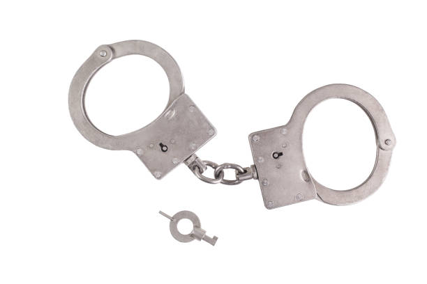 istock Handcuffs and key isolated on white background 1381879594