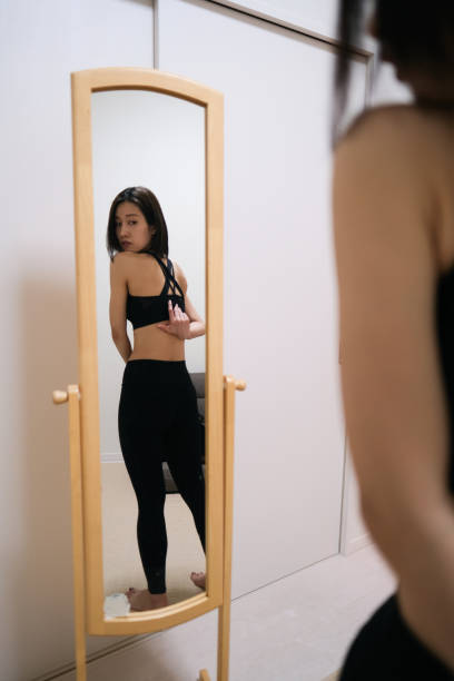 istock Young woman looking at herself by mirror 1381902076