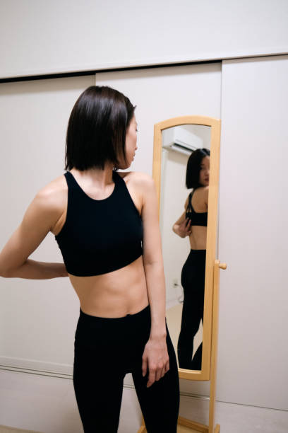 istock Young woman looking at herself by mirror 1381902618