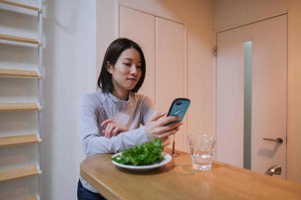 istock Young woman eating salad for dieting 1381903716