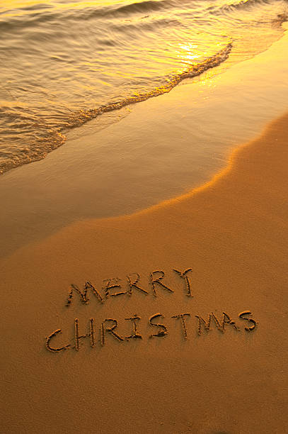 istock Merry Christmas handwritten in sand on a beautiful beach 138190535