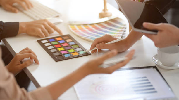 istock Designers working together in the office, discussing the interior design. 1381918458