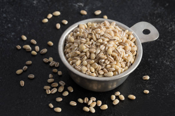 Uncooked Pearled Barley in a Measuring Cup stock photo