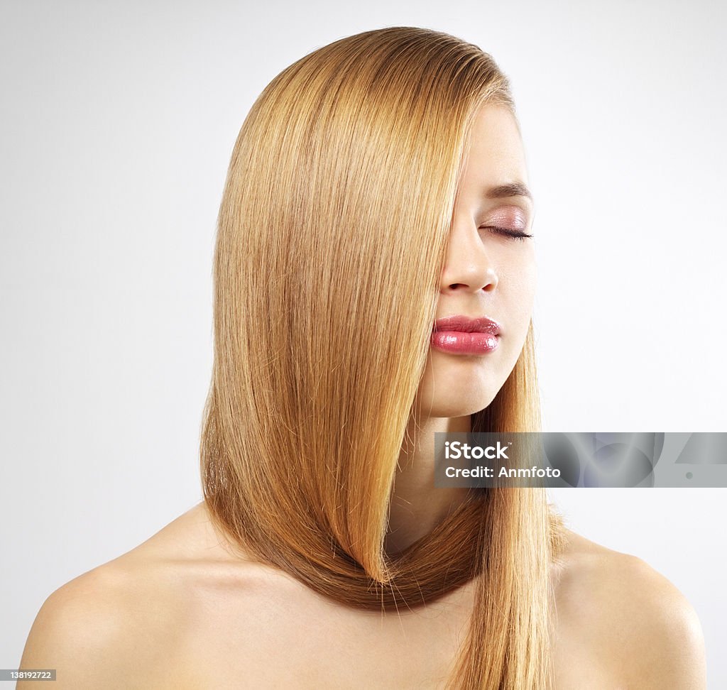 Pretty girl with long hair Pretty girl with long hair on a gray background Photography Stock Photo