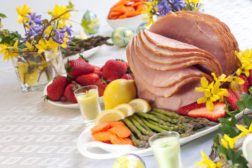 Easter ham with vegetables and fruits on the table