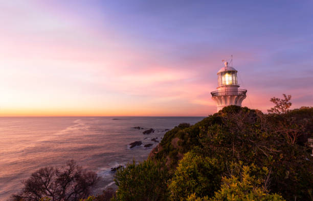 Sunrise over Lighthouse at Seal Rocks Australia stock photo
