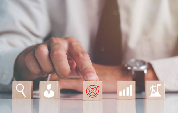 istock Success and business target concept. Hand stack woods block step on table with icon Action plan, Goal and target, project management, company strategy development. 1381963397