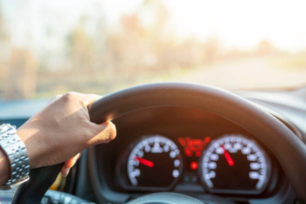 istock Young male driving car on the road 1381963571