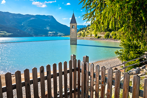 Submerged bell Tower of Curon Venosta or Graun im Vinschgau on Lake Reschen landscape view, South Tyrol region Italy