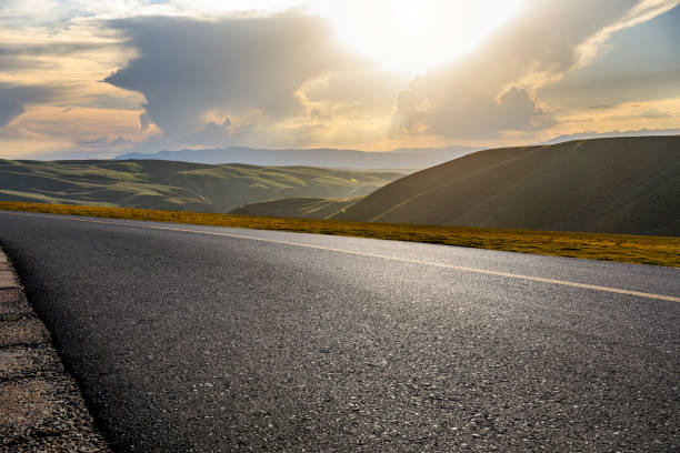 istock Asphalt road and mountain at sunrise 1381990208