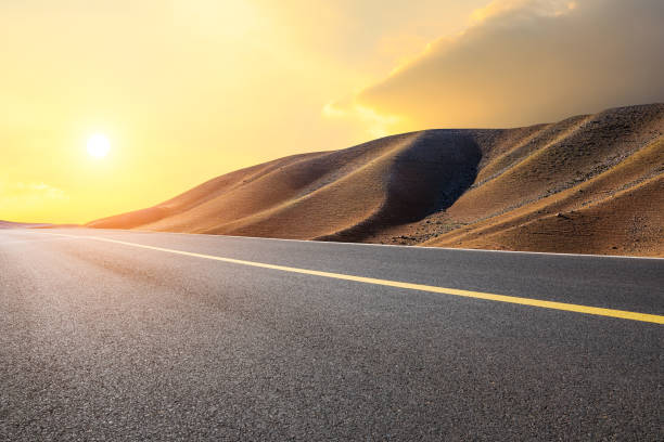 istock Asphalt road and mountain landscape at sunset 1381990721