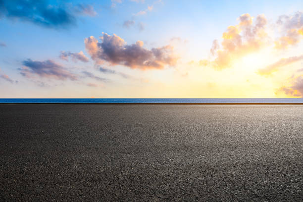 istock Asphalt road and lake with cloud landscape 1381990724