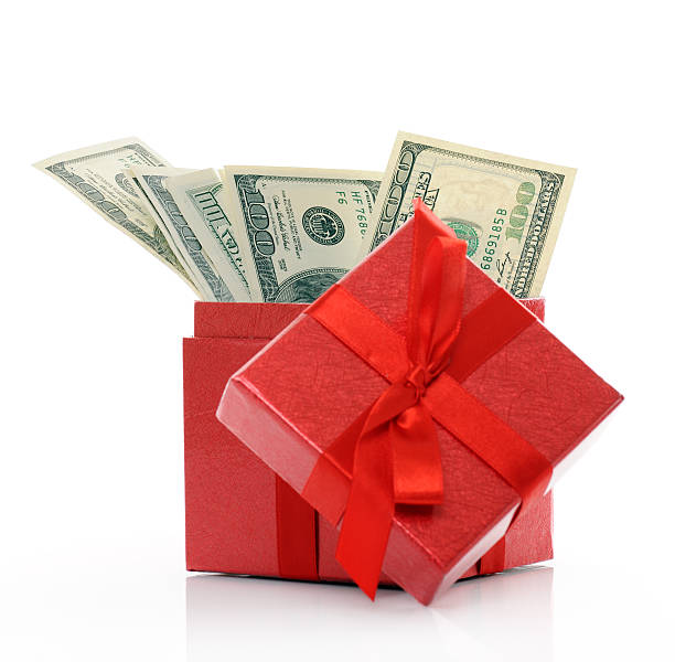 istock A red gift box with ribbon filled with cash 138199414