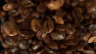 istock Super slow motion coffee beans jumping towards camera 1382002889