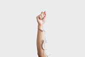 Hand rising up with unchained handcuff, on white backgrounds