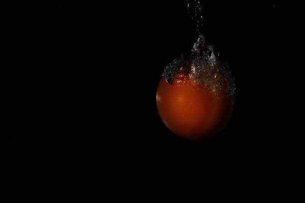radishes splashing in the water on a black background con copy space