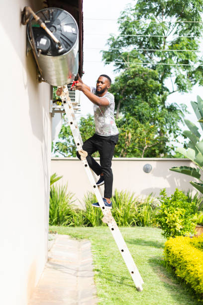 istock Man on ladder trying to do home maintenance 1382032749