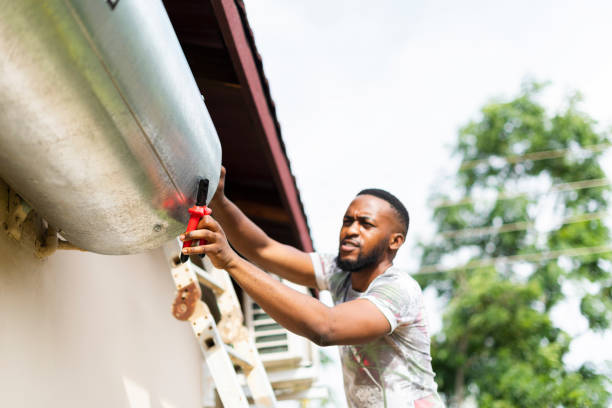 istock Close up man using tools trying to fix hot water geyser 1382032754