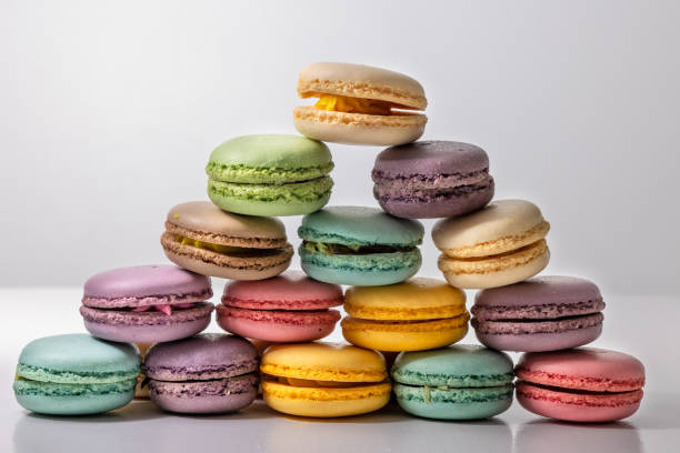 istock Colorful macaroons on a wooden table white background 1382058876